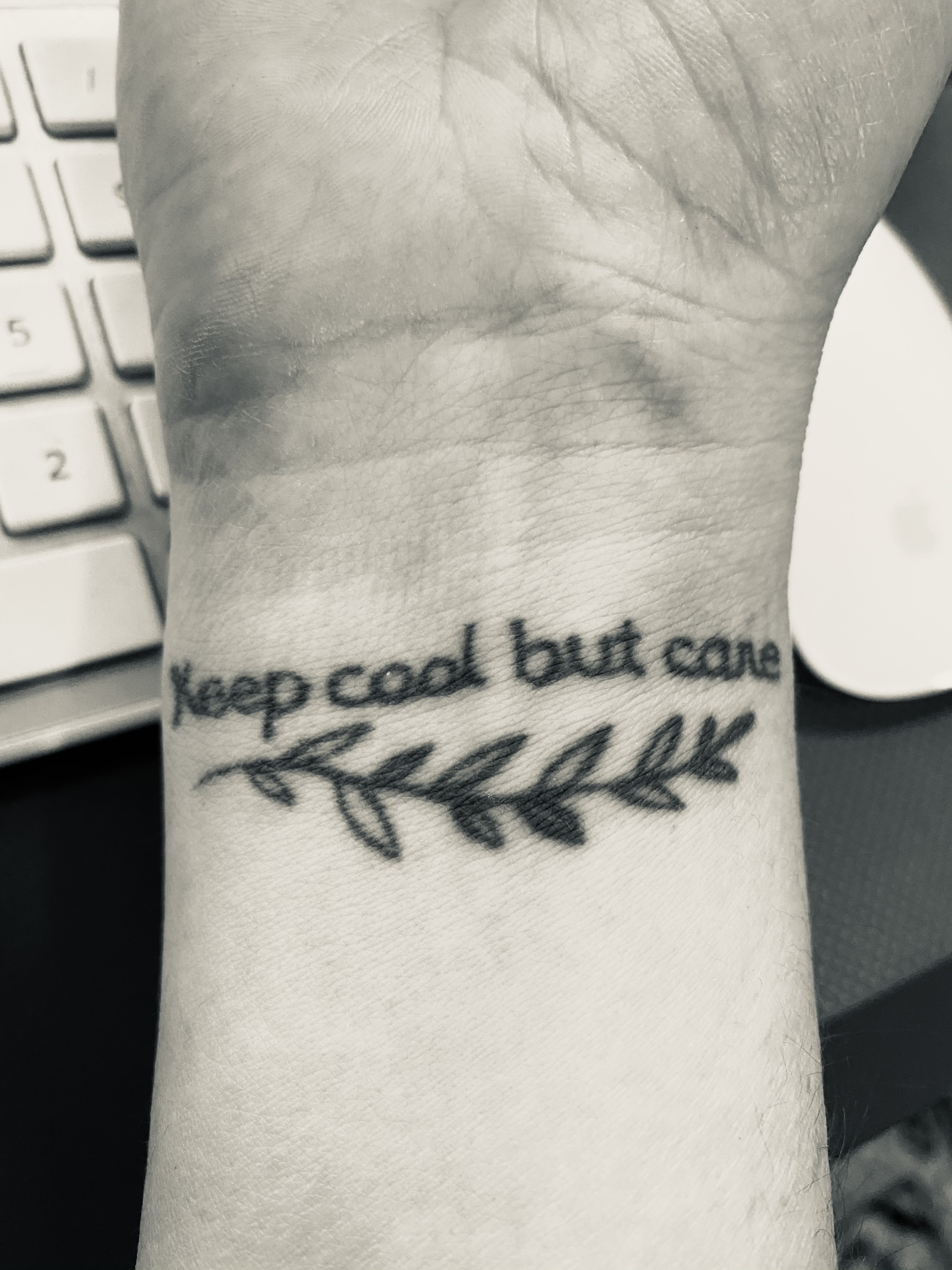 “Keep cool but care.” tattoo on wrist