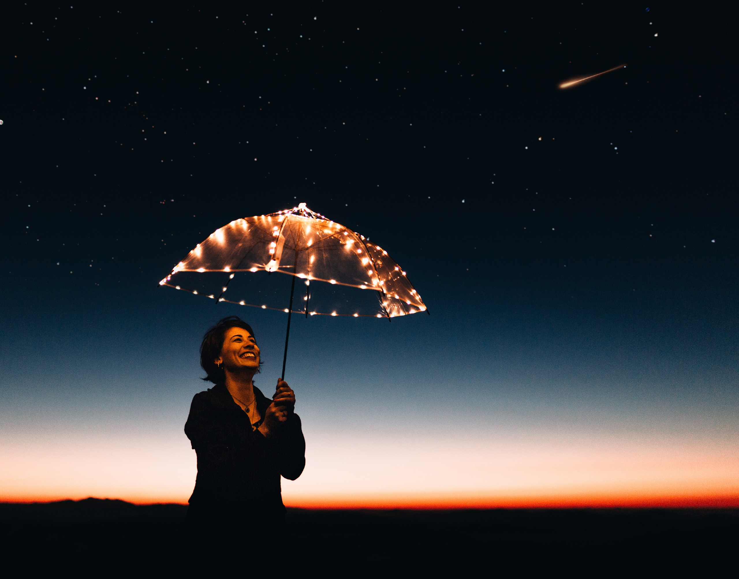 person holding umbrella with lights