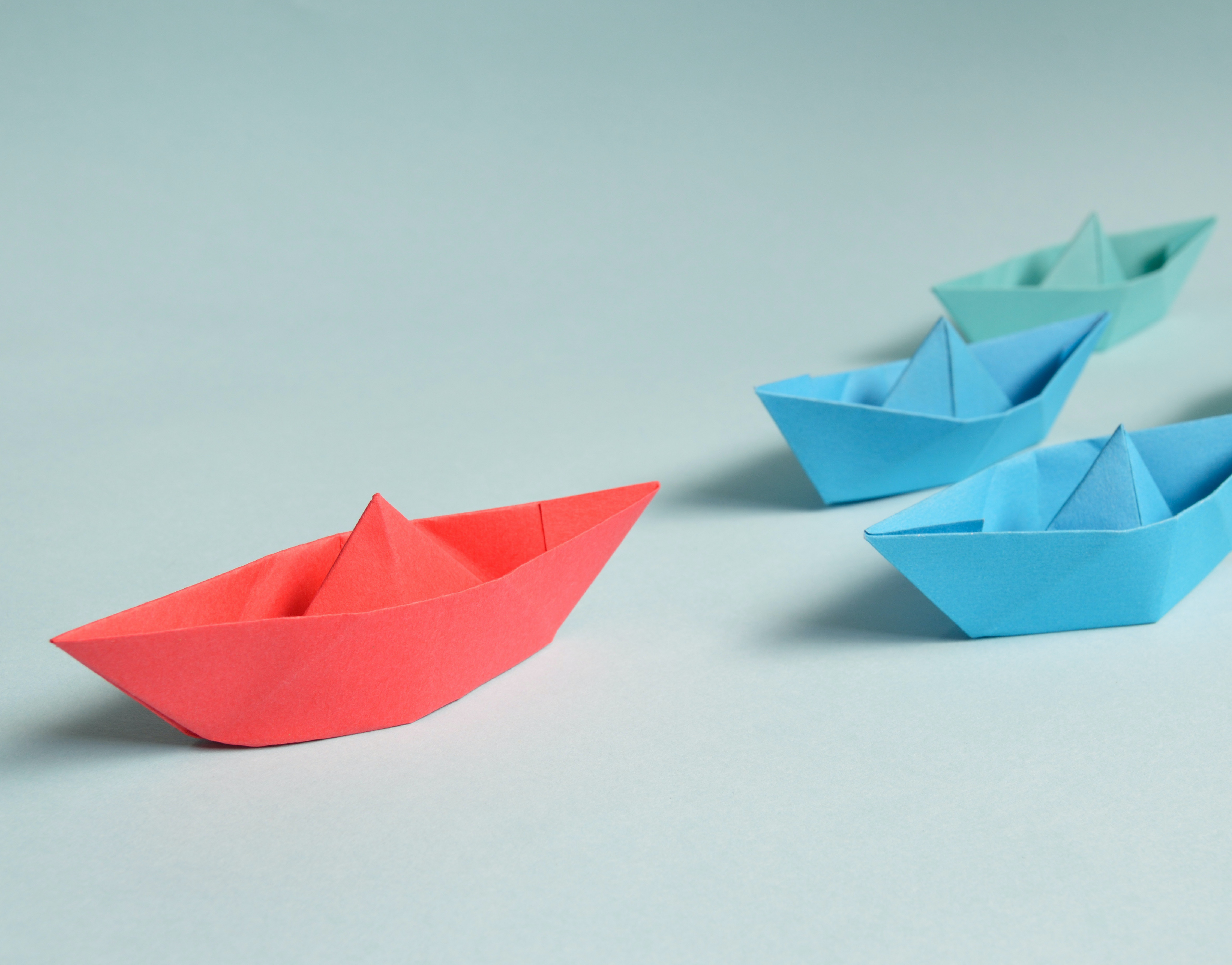 red paper boat, two blue paper boat & one green paper boat